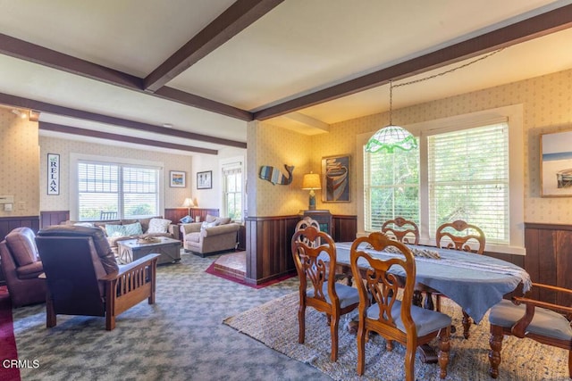 carpeted dining area featuring a wainscoted wall and wallpapered walls