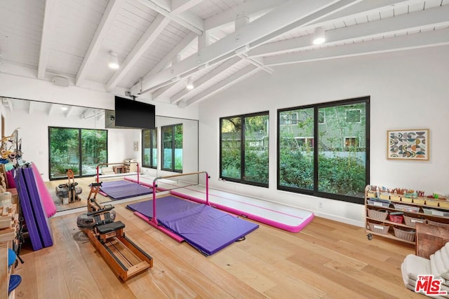 workout area with vaulted ceiling, hardwood / wood-style floors, and wooden ceiling