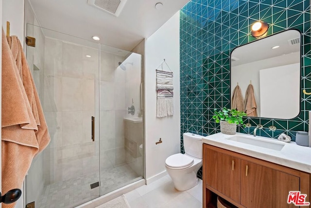 bathroom featuring walk in shower, toilet, vanity, tile patterned flooring, and backsplash