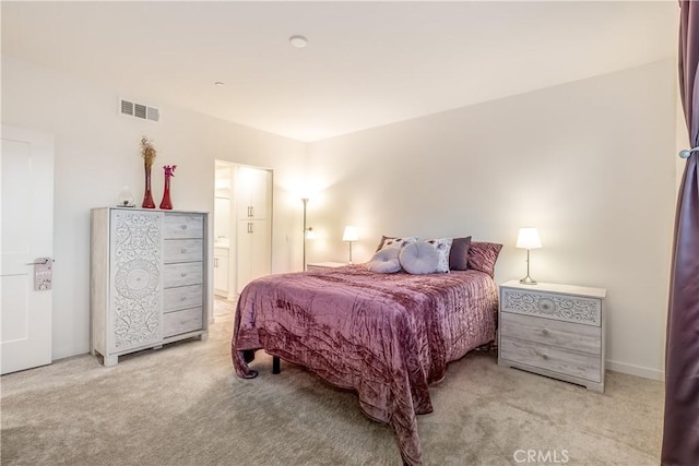 carpeted bedroom with ensuite bathroom