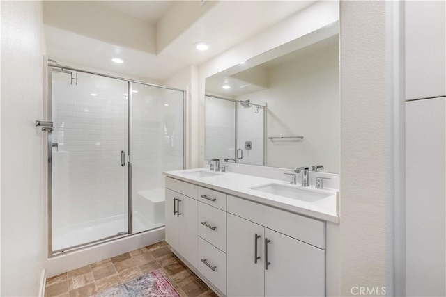 bathroom with an enclosed shower and vanity