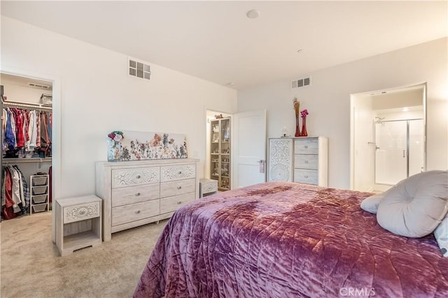 carpeted bedroom featuring a closet and a walk in closet