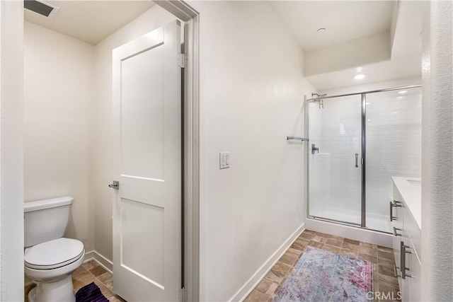 bathroom featuring toilet, walk in shower, and vanity