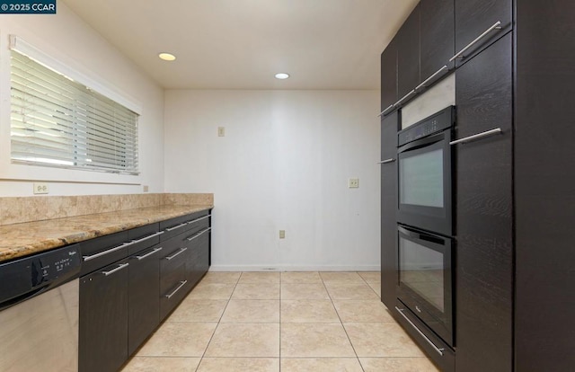 kitchen featuring light tile patterned floors, stainless steel dishwasher, and light stone countertops