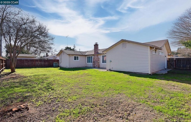 rear view of property featuring a yard