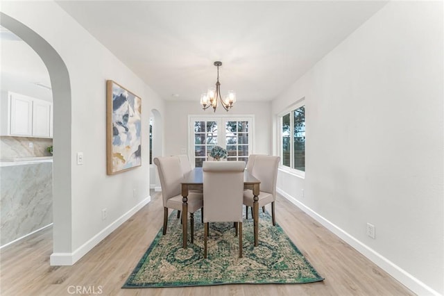 dining area with a chandelier and light wood-type flooring