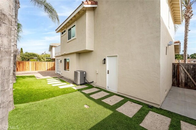 back of house featuring central AC unit and a patio area