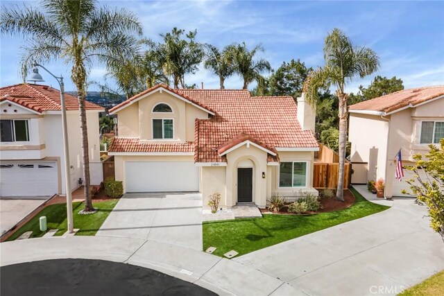 view of front of house with a garage and a front lawn