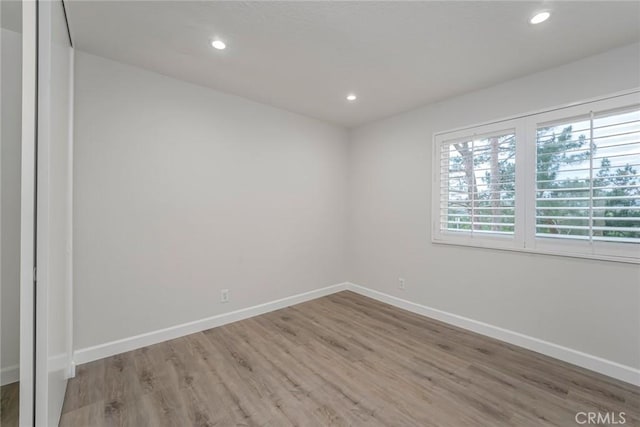 empty room with light hardwood / wood-style flooring