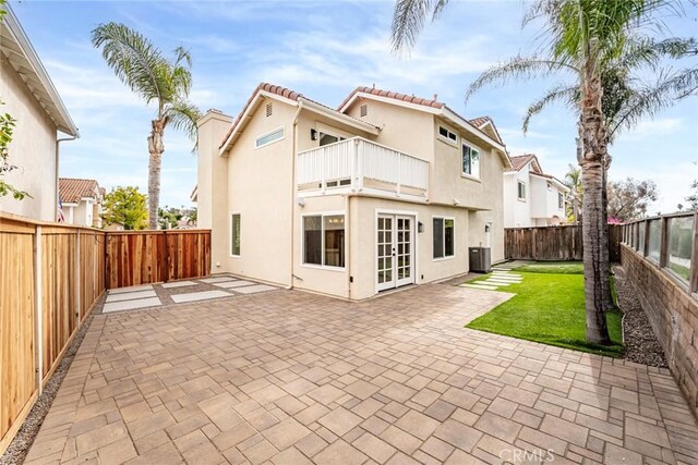 back of house with a patio, a balcony, central AC, and french doors