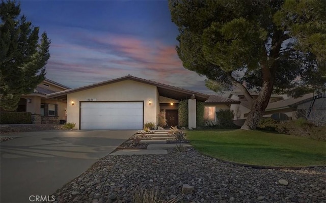 view of front of home with a garage and a yard