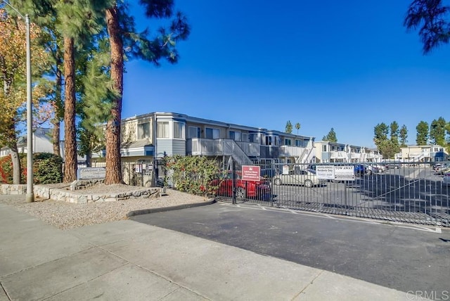 view of road with a residential view and a gated entry