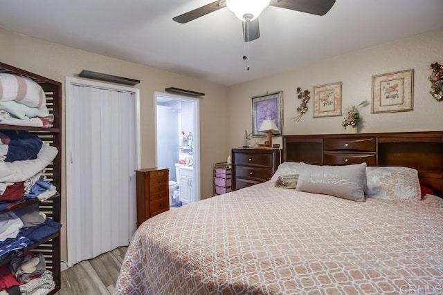 bedroom with ceiling fan, connected bathroom, and wood finished floors