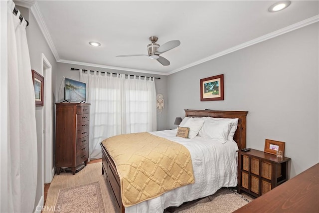 bedroom with light wood-type flooring, ceiling fan, and crown molding