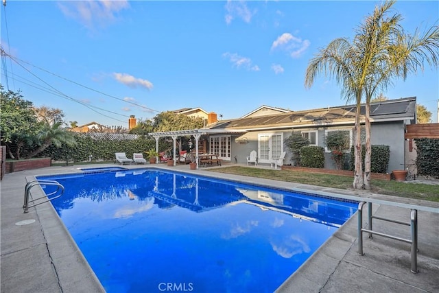 view of swimming pool with a patio area, french doors, and a pergola