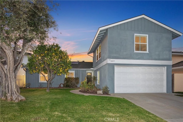 view of front of property featuring a garage and a lawn