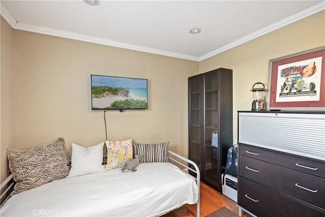 bedroom with crown molding and wood-type flooring