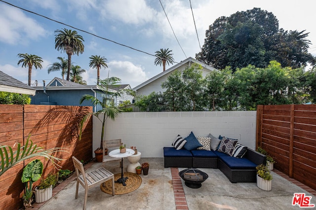 view of patio / terrace featuring an outdoor living space with a fire pit