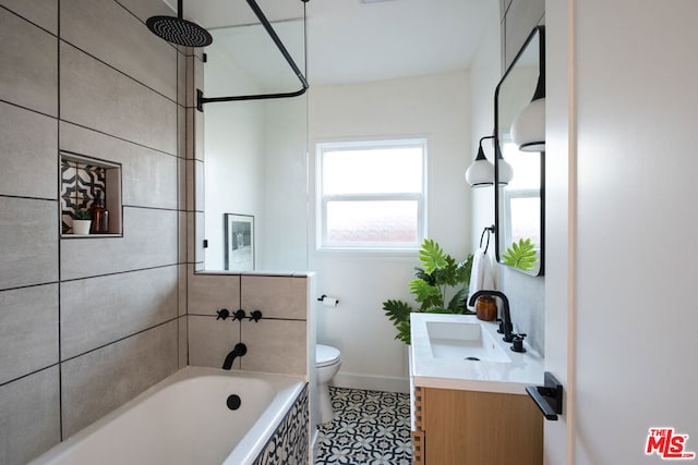 full bathroom with toilet, vanity, tile patterned flooring, and tiled shower / bath