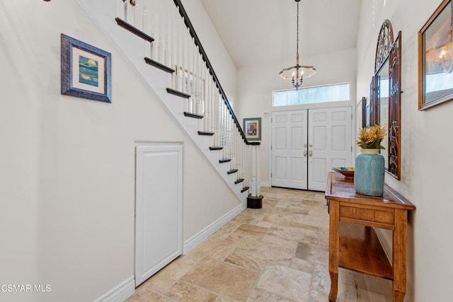 foyer featuring a chandelier