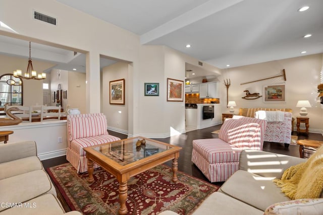 living room featuring dark hardwood / wood-style flooring and a notable chandelier