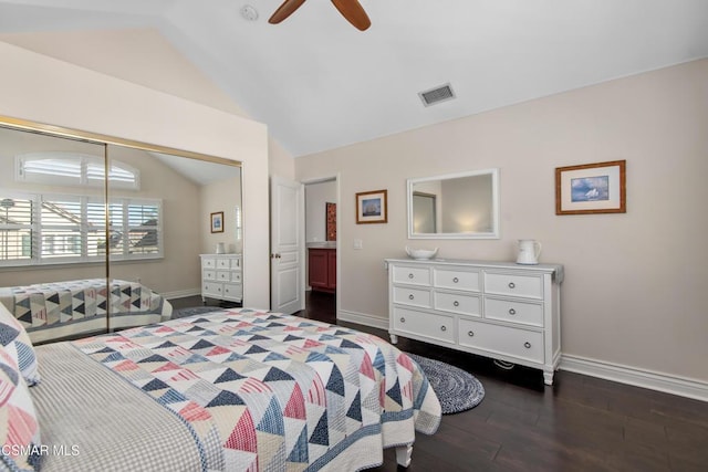 bedroom with ceiling fan, dark hardwood / wood-style flooring, vaulted ceiling, and a closet