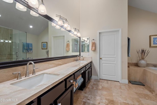 bathroom featuring walk in shower, vanity, and vaulted ceiling