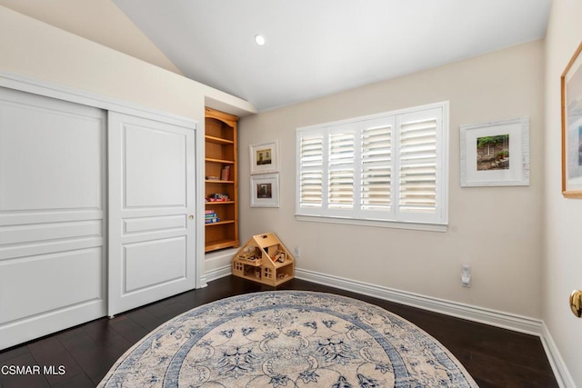 sitting room featuring vaulted ceiling and dark hardwood / wood-style flooring