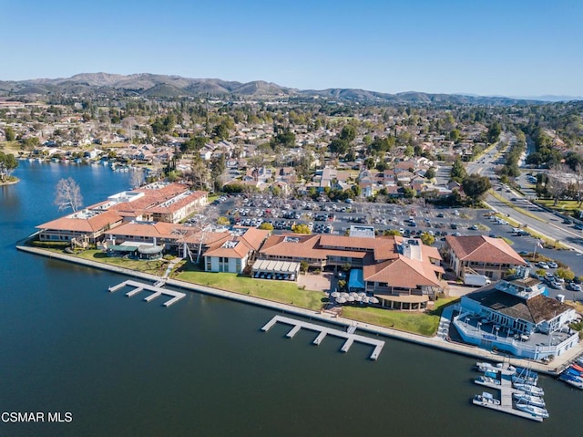 birds eye view of property with a water and mountain view