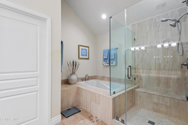 bathroom with lofted ceiling, separate shower and tub, and tile patterned flooring