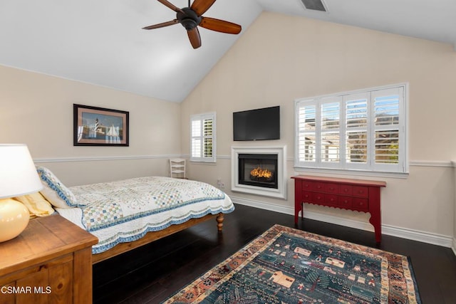 bedroom with ceiling fan, dark hardwood / wood-style flooring, and high vaulted ceiling