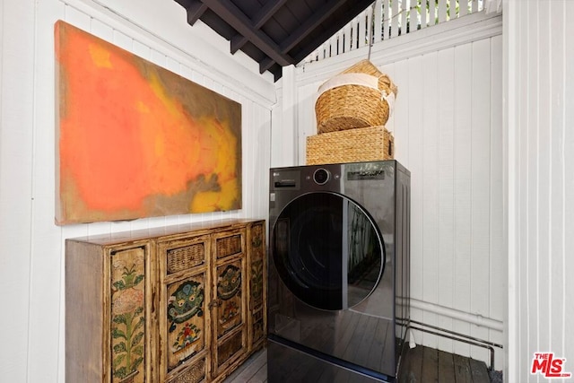 clothes washing area featuring hardwood / wood-style flooring and washer / dryer