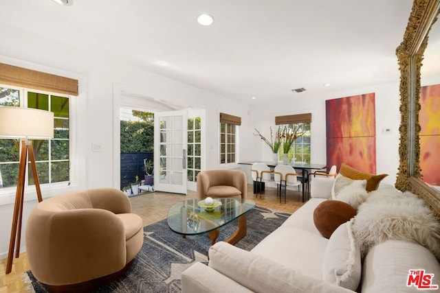 living room with a wealth of natural light and light parquet flooring