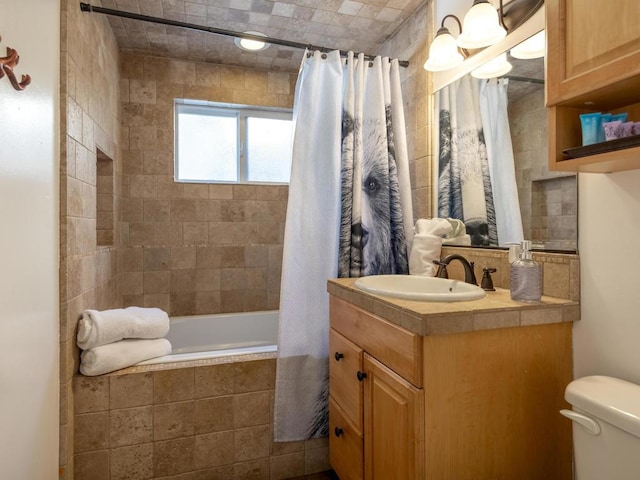 full bathroom with toilet, vanity, and shower / tub combo