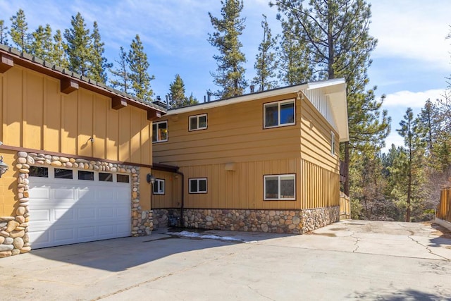 view of side of home featuring a garage