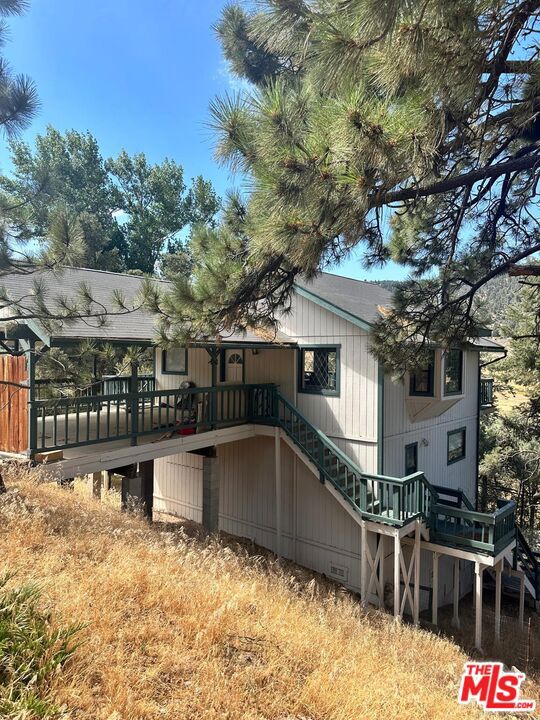 rear view of property with a wooden deck