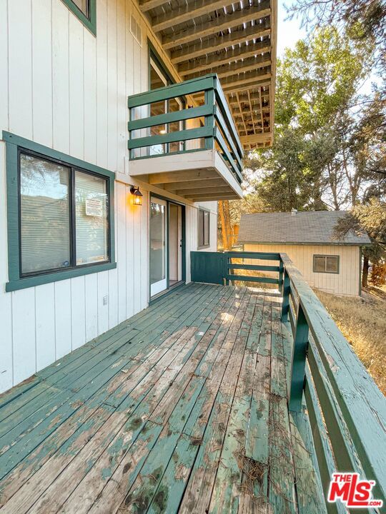 wooden deck with an outbuilding