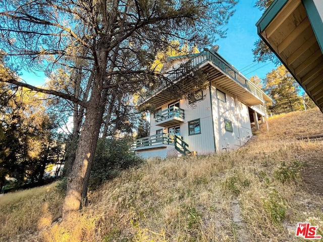 view of side of home with a balcony