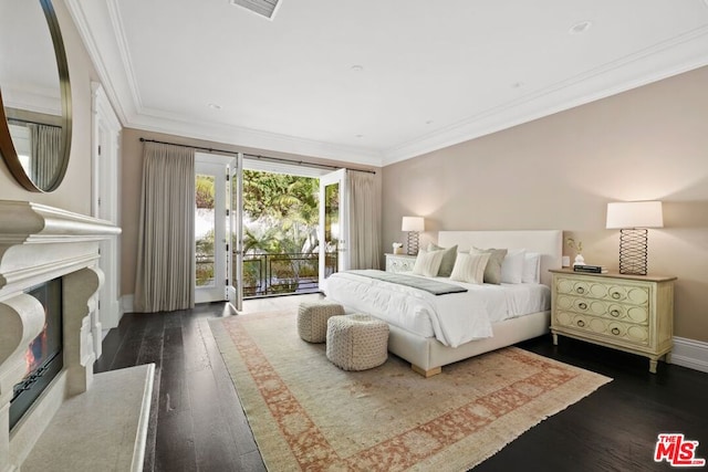 bedroom with dark hardwood / wood-style floors, ornamental molding, access to outside, and a fireplace