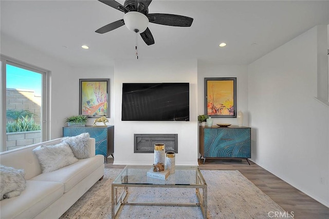 living room featuring hardwood / wood-style flooring and ceiling fan