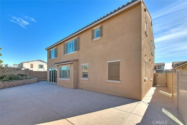 back of house with a patio area