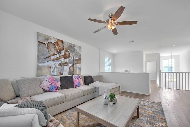 living room with hardwood / wood-style floors and a healthy amount of sunlight