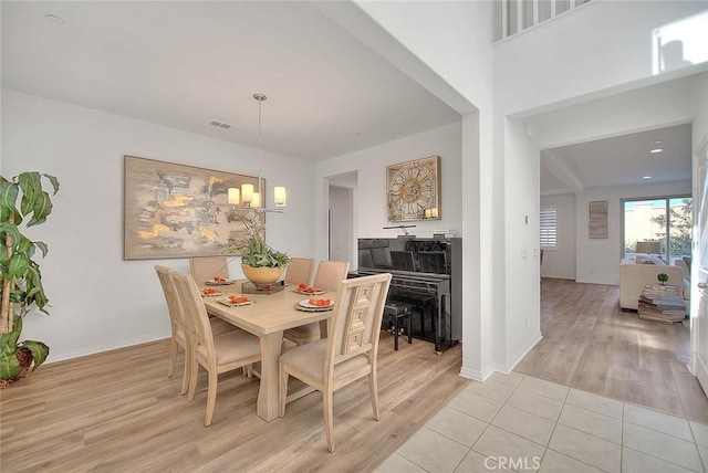 dining space featuring a chandelier and light tile patterned floors