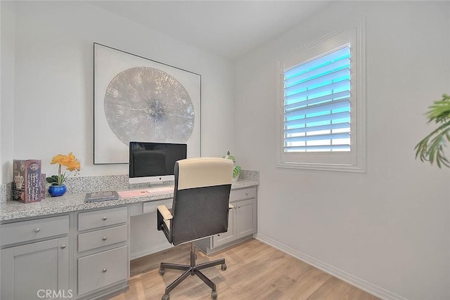 office with light wood-type flooring