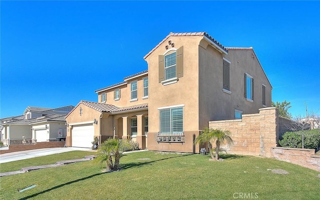 mediterranean / spanish-style house with a front yard and a garage