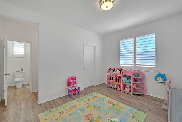 playroom featuring radiator, light hardwood / wood-style flooring, and plenty of natural light