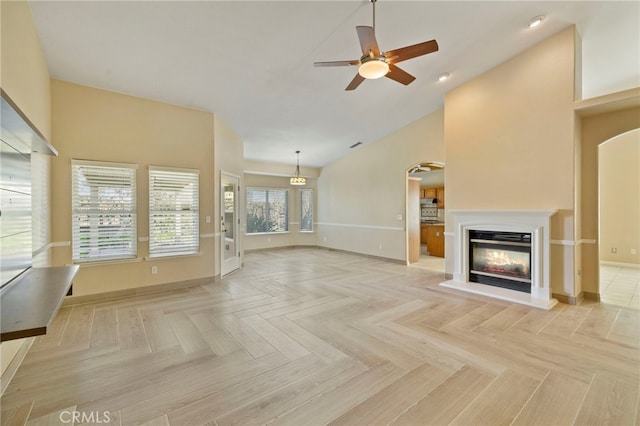 unfurnished living room featuring ceiling fan and light parquet flooring