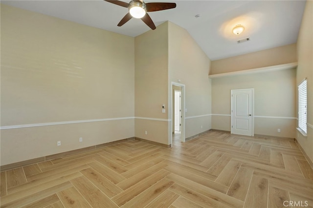 empty room featuring ceiling fan and light parquet flooring