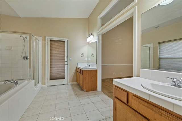 bathroom featuring separate shower and tub, vanity, tile patterned flooring, and vaulted ceiling