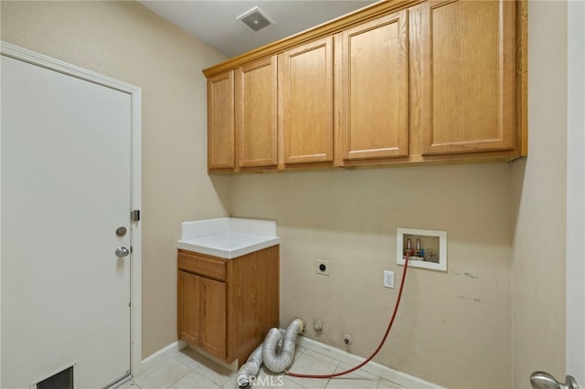 laundry room featuring washer hookup, light tile patterned floors, hookup for an electric dryer, gas dryer hookup, and cabinets